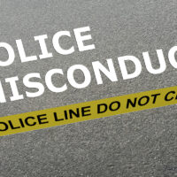 Police Misconduct concept Police misconduct caption behind yellow tape for police line do not cross