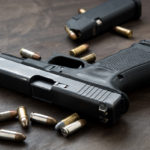 Gun with ammunition on dark background. Gun with ammunition on dark background.