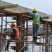 Construction workers dismantling beam formwork