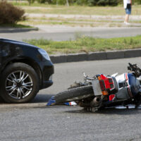 crash moto bike and car on road