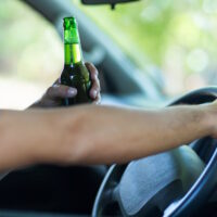 Cropped hands of man with alcohol