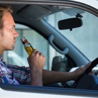 Guy drinking alcohol while driving Guy drinking alcohol while driving