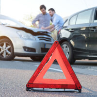 Two men reporting a car crash for the insurance claim