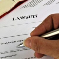 hand signing lawsuit paper hand signing lawsuit paper