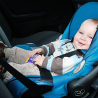 Child seated in blue rear facing car seat Child seated in blue rear facing car seat
