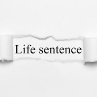 Life sentence on white torn paper