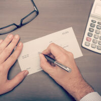 Man writing a check Man writing a check