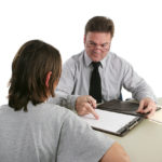 Guidance counselor looking at student's record Guidance counselor looking at student's record