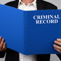 criminal record blue file being read by businesswoman
