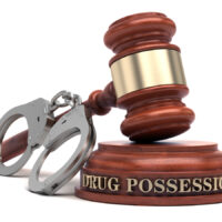 Drug Possession text on sound block & gavel Drug Possession text on sound block & gavel