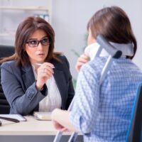 Injured employee visiting lawyer for advice on insurance