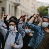 People marching together in a protest People marching together in a protest