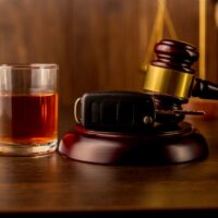 Whiskey with car keys and handcuffs. Concept for drinking and driving Whiskey with car keys and handcuffs. Concept for drinking and driving