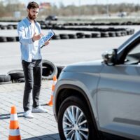 Instructor teaching to drive a car on the training ground Instructor teaching to drive a car on the training ground