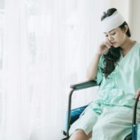 Lonely accident patients injury woman on wheelchair in hospital want to go home – medical concept Lonely accident patients injury woman on wheelchair in hospital want to go home – medical concept
