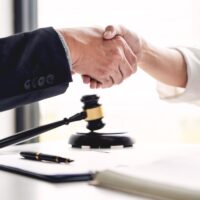 Handshake after cooperation between attorneys lawyer and clients discussing a contract agreement hope of victory over legal fighters, Concepts of law, advice.