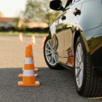 Car and traffic cones, driving school concept