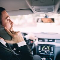 Business Man using his phone while driving the car Business Man using his phone while driving the car