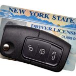 New York State driver license and car key isolated on white background.