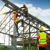 construction worker control in the construction of roof structures and worker wear safety height equipment to install the roof. Fall arrestor device for worker with hooks for safety body harness, Worker as in the construction site