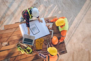 Team of engineer and architects working, meeting, discussing,designing, planning, measuring layout of building blueprints at construction site,Top view,Construction concept.